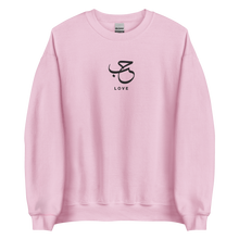 Load image into Gallery viewer, Pink unisex sweater featuring ‘Love’ embroidered in elegant Arabic calligraphy. Soft, comfortable, and stylish design perfect for everyday wear.