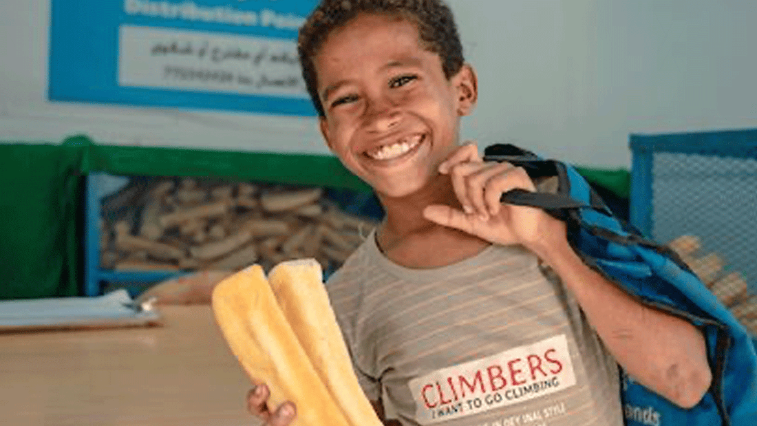 Boy holding a loaf of bread