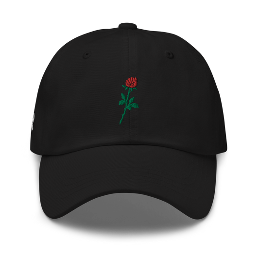 Sabr.Style classic black dad hat featuring the 'Rose of Resistance' design—an embroidered rosebud shaped like a fist, symbolizing strength and defiance. Adjustable strap and curved visor for a comfortable fit.